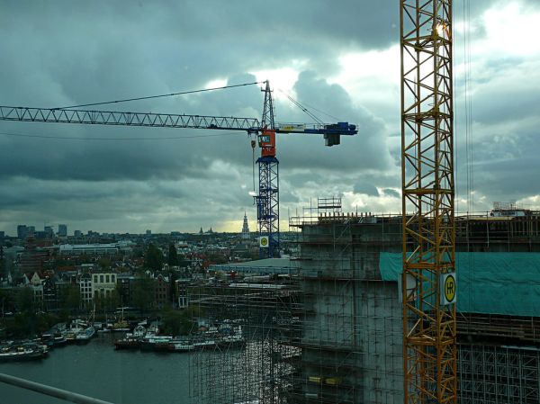 2006.10 - 'Building to the sky' - Amsterdam photos and pictures, construction-site in light of late afternoon sky in Fall above the city with cranes at the Oosterdok; Dutch city + geotag, Fons Heijnsb...