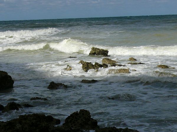 2007.09 - 'Still life seascape of light and shadows', a splashing surf on rocks on the shores of Petit-Dalle in Normandy France with a quiet sea; French landscape photography, Fons Heijnsbroek