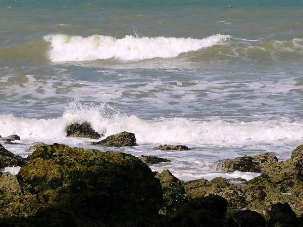 2007.09 - 'Sunny still life seascape of splashing surf'. and granular rocks on the shore near Petit-Dalle in Normandy France; French landscape photography, Fons Heijnsbroek