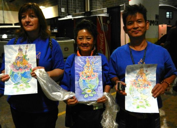 3 Pleased Volunteers holding original watercolor paintings of Padmasambhava, Guru Rinpoche, with khatas, as offerings, preparing for mandala offering to His Holiness 14th Dalai Lama of Tibet, Kalachak...