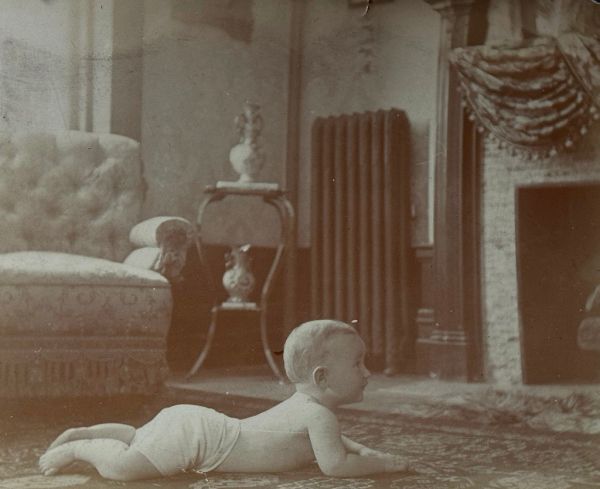 Baby laying on floor in the living area