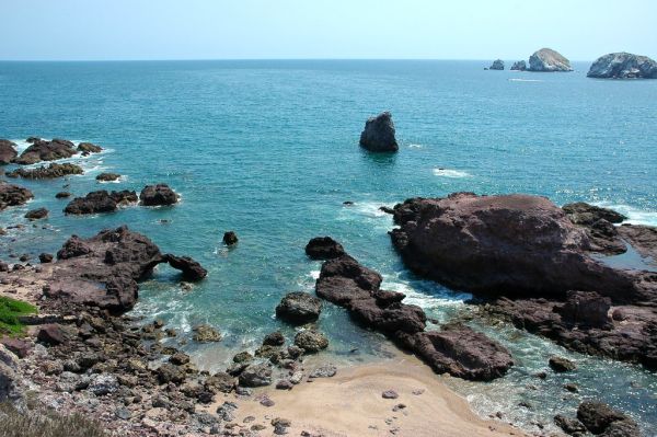 Beauty Test Beach, the little arch, with islands and speedboat, South Mazatlan, Sinaloa, Mexico