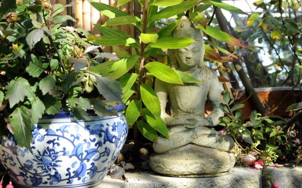 Buddha meditating under leaves, work never ends kids so meditate no matter what happens, blue and white planter, fushia, snall shell, mirror, bamboo fence, A Garden for the Buddha, Seattle, Washington...