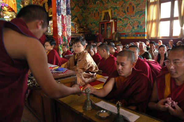 Ceremony monk distributes vajras to the lamas and Sakya tulkus, other practitioners, offering rice, ritual bells, pechas, shrine, murals depicting Lord Buddha's life story, Lamdre, Tharlam Monastery o...