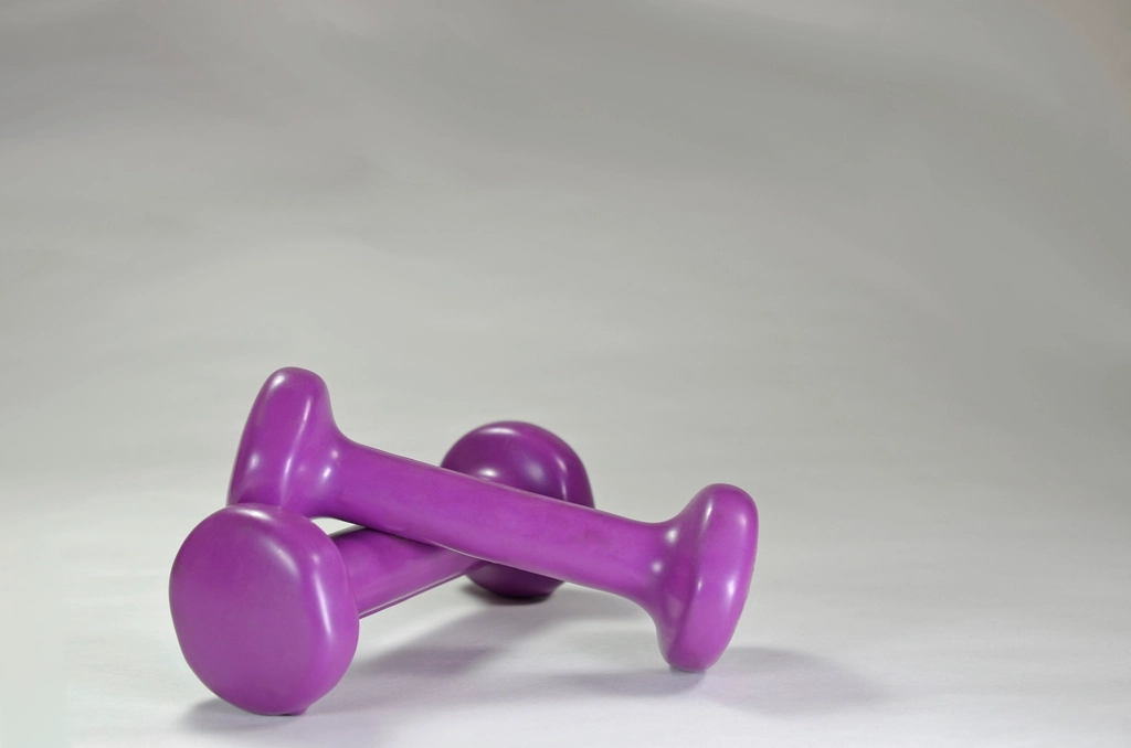 Closeup purple gym dumbbell