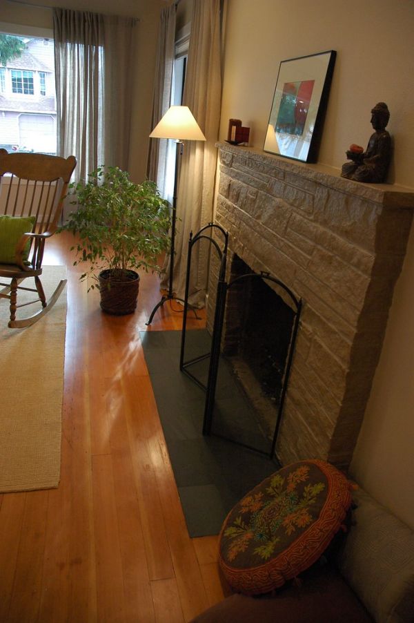 Complete Makeover - painted fireplace, refinished floor, Zen slate hearth, interior design, with Buddha statue, original art, simple lamp, rocking chair, ficus plant, green pillow, Seattle, Washington...