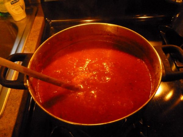 Cooking down the tomatoes for pasta sauce