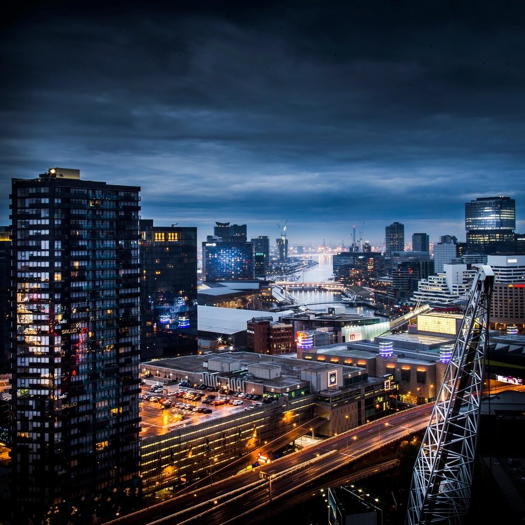 Cranes high-rises city skyline dark