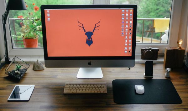 Desk with Apple iMac, iPad Mini, iPhone, Keyboard, and Mouse