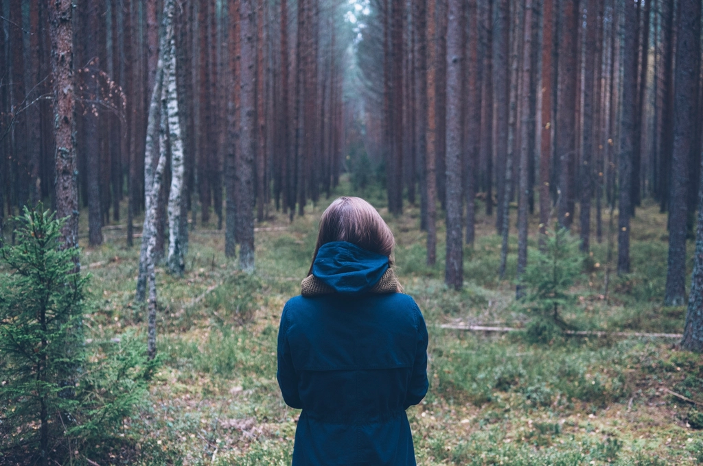 Free woman standing forest trees