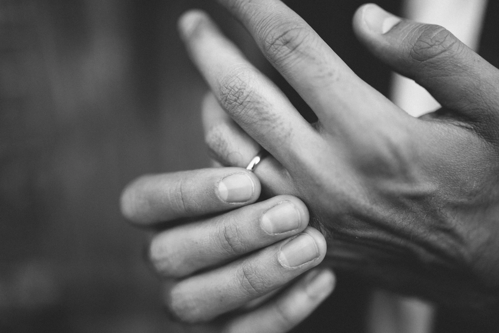 Groom touching his wedding ring