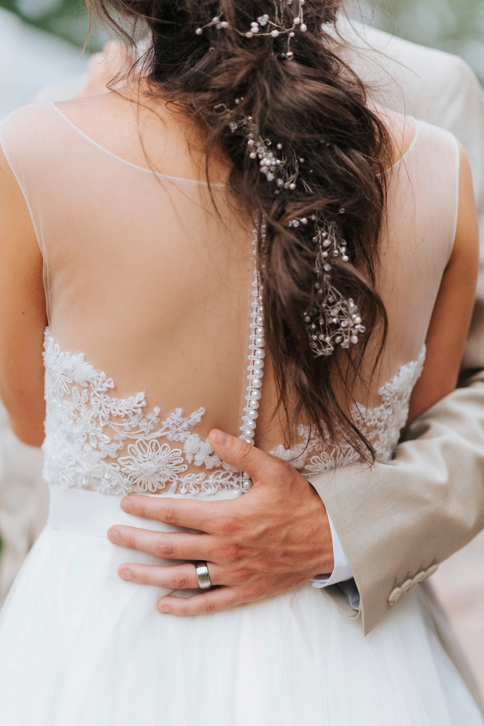Groom wraps arm bride's back