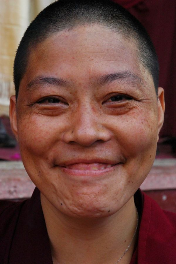 Happy face of a Tibetan Nun, on Bodhisattva Day, Tharlam Monastery, Kathmandu, Nepal
