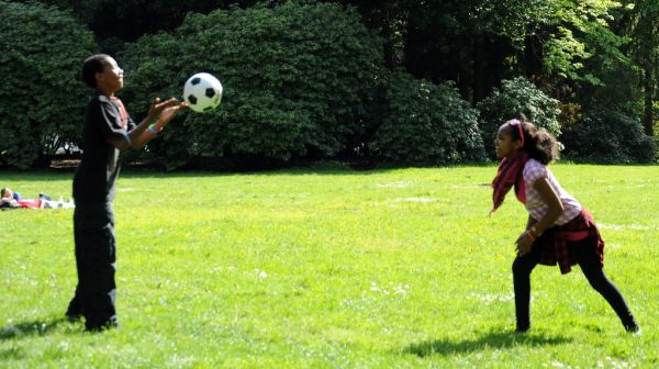 He tosses. 1 on 1 volley ball without a net, Eritrean children at play, Eritrea independence anniversary celebration, (land of Punt), Volunteer Park, Capitol Hill, Seattle, Washington, USA