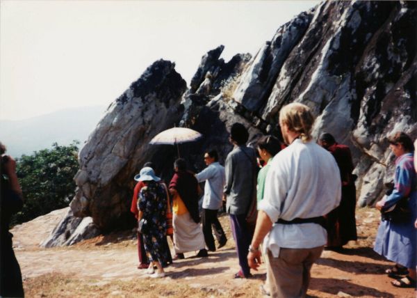 His Holiness Jigdal Dagchen Sakya walking under a white umbrella held by his son, sangha, pilgrimage, Vulture Peak, India