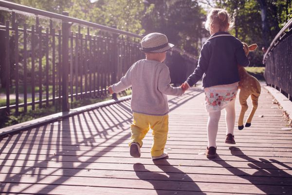 Kids running across the bridge