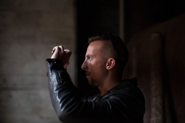 Man in Black Jacket Holding Camera