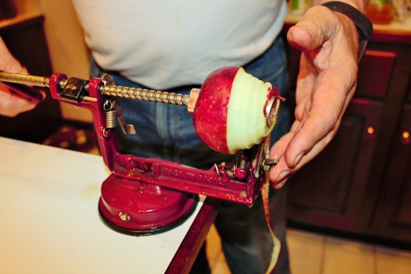 Man using apple peeler