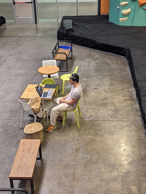 Man using computer in climbing gym