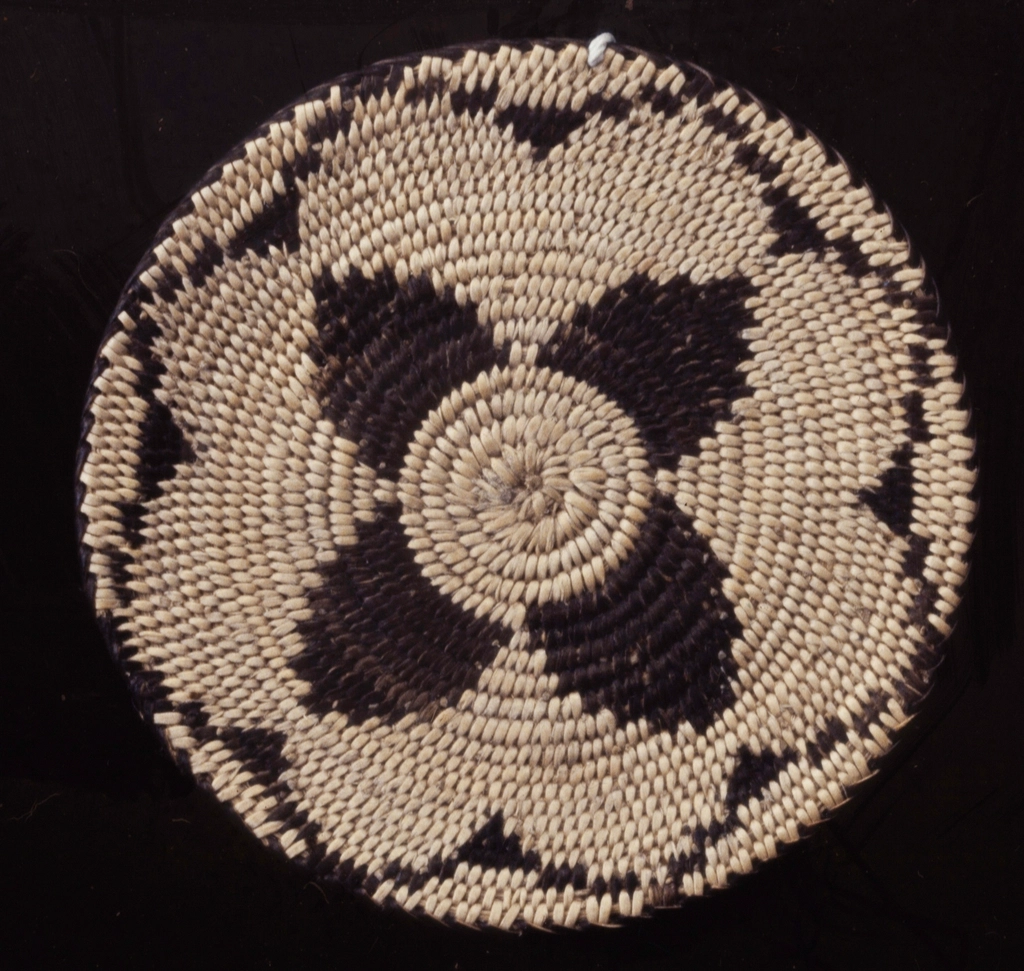 Miniature flat round plaque; coiled
