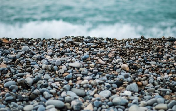 Pebbles on Seashore by Ocean