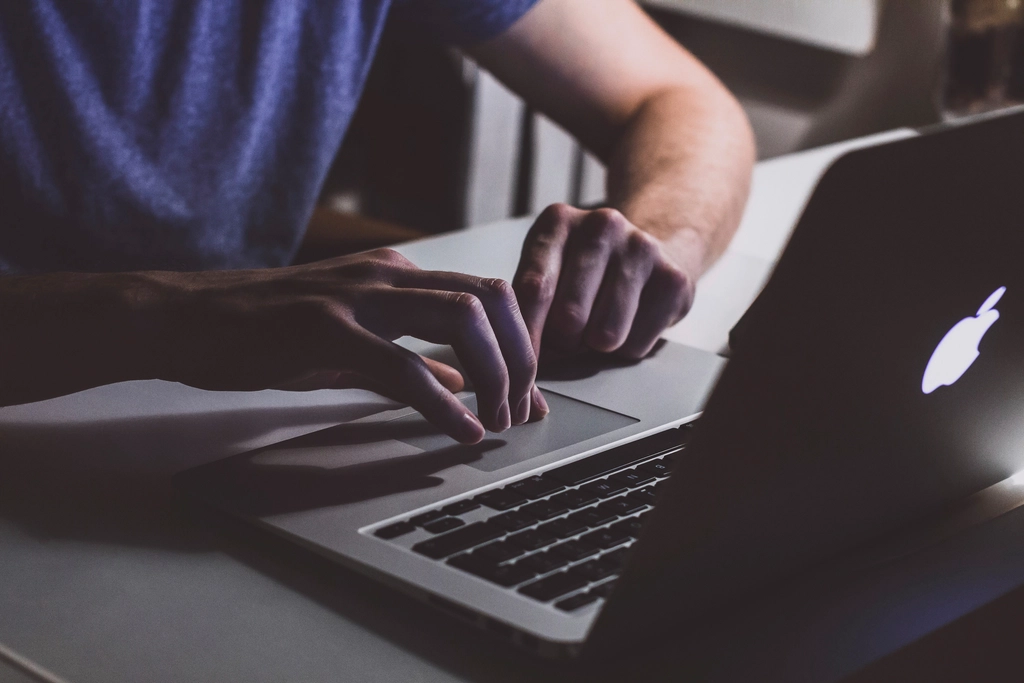 Person working Macbook laptop, location