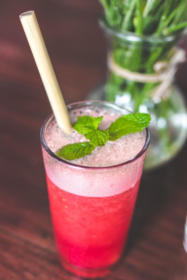 Raspberry lemonade on a wooden table. Iced summer drink.