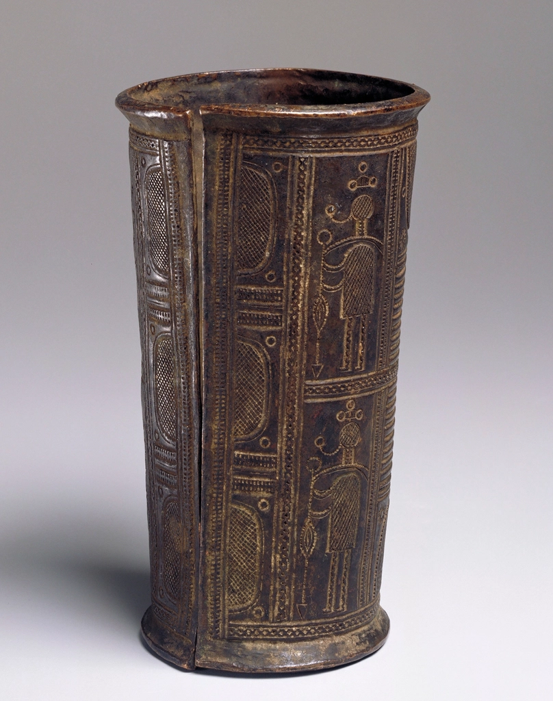 slightly tapering cylindrical shape; decorated