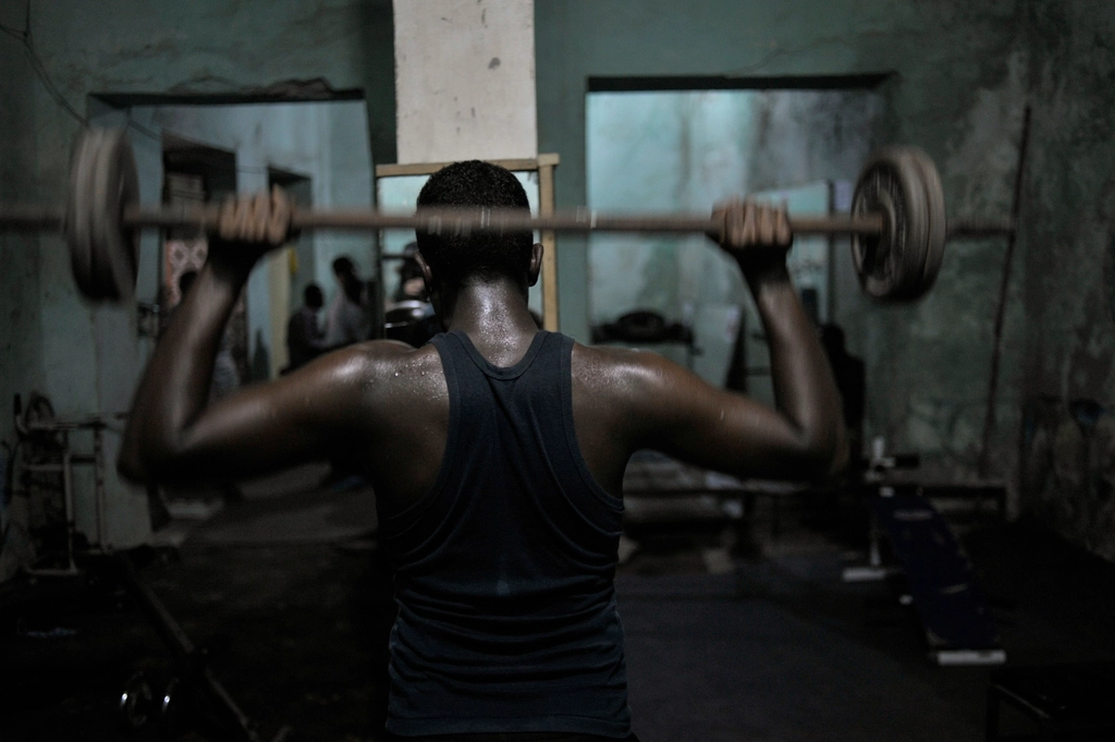 Somali man lifts weights gym