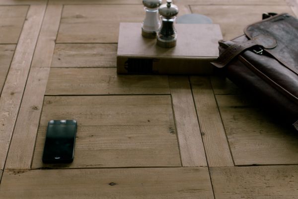 Still Life of iPhone, Brown Satchel, Book, and Salt and Pepper Shakers