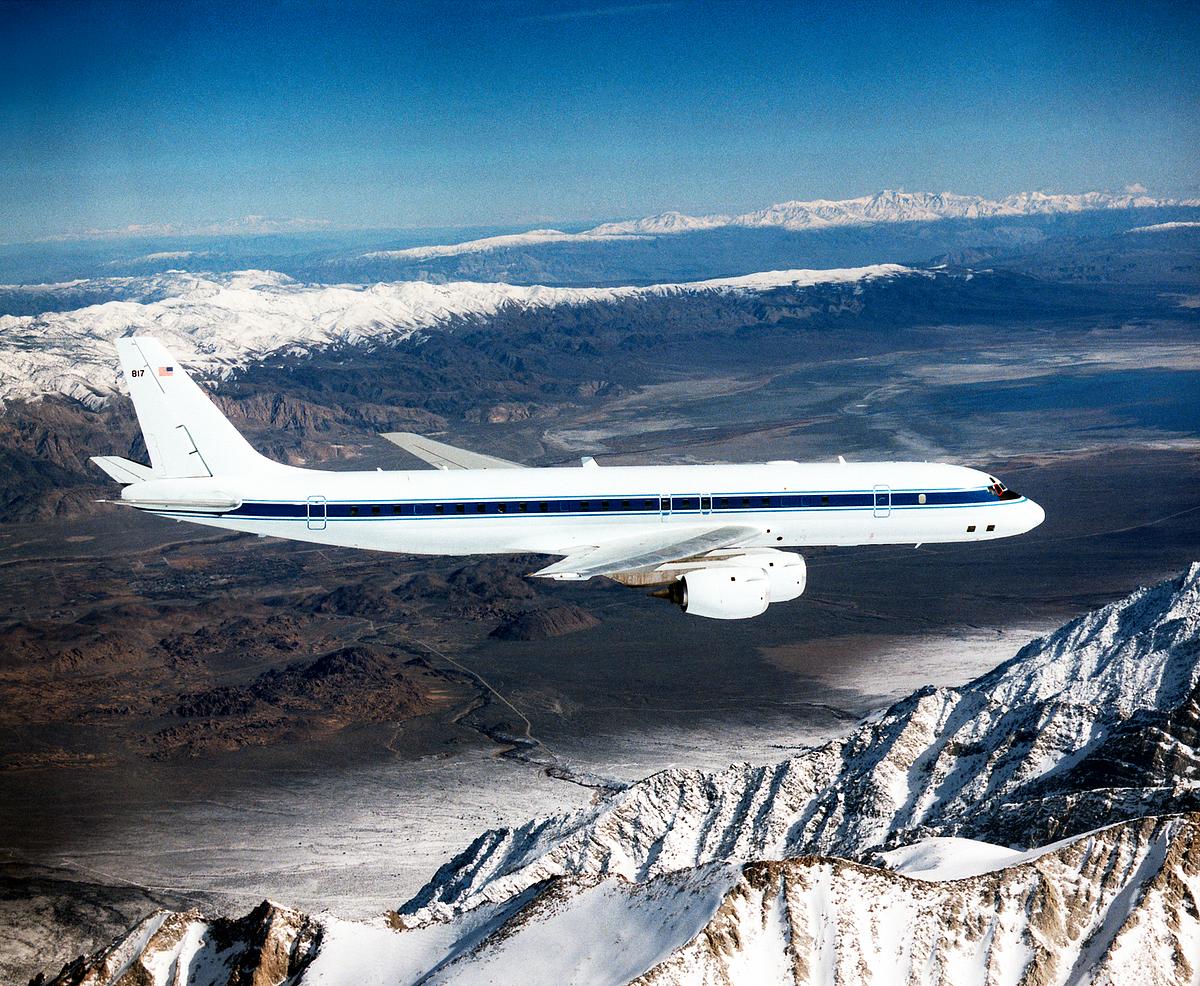 The DC-8 in flight near Lone Pine, Calif. In the foreground are the Sierra Nevada Mountains, covered with winter snow. In the distance are the White Mountains. Original from NASA . Digitally enhanced...
