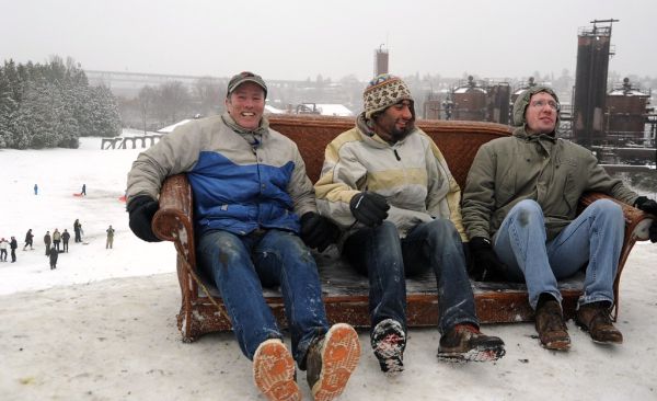 Three guys couch surfing, coats, boots, levis, snow day, people sledding, Gasworks Parks, hill, Wallingford, Seattle, USA