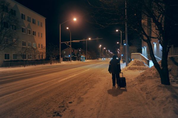 Walking home from the bus with a roller cart, in the tamed snow, 'I' Street, street lights, apartment buildings, houses, Anchorage, Alaska, USA
