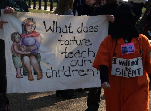 'What Does Torture Teach Our Children?' Banner & Orange Jumpsuited, Black Hooded Protester With 'I Will Not Be Silent' Sign At The Public Witness Against Torture (Washington, DC: March 10, 2008)