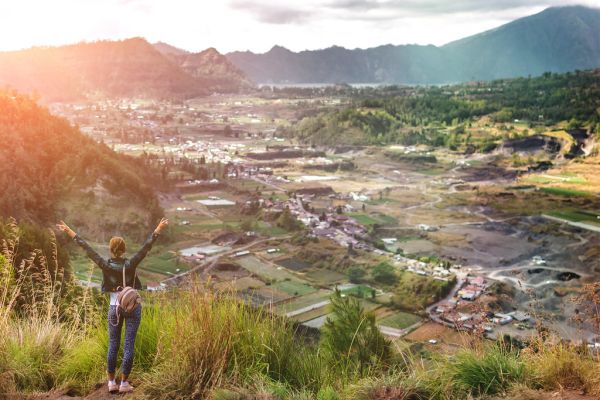Woman sstanding on mountain in morning. Bali island.