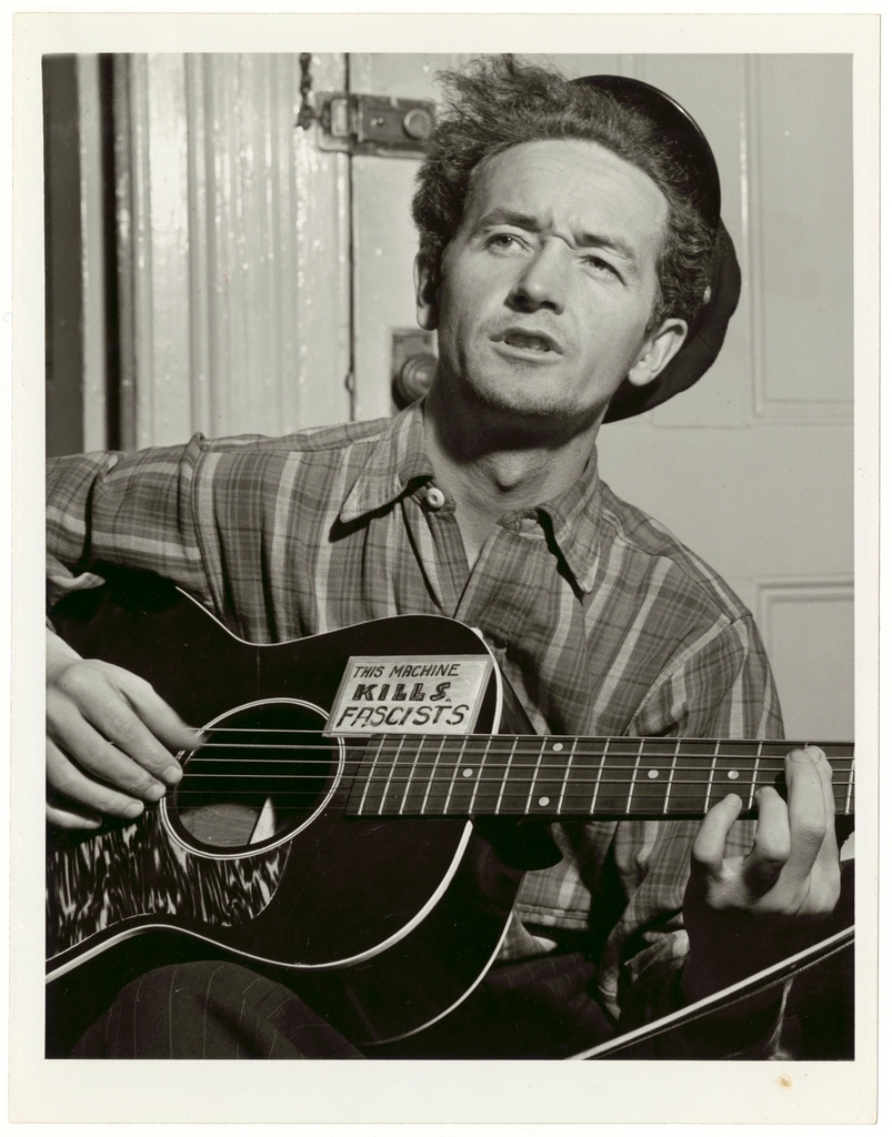 Woody Guthrie, half-length portrait, facing