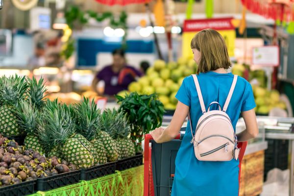 Young woman in supermarket on Bali island.