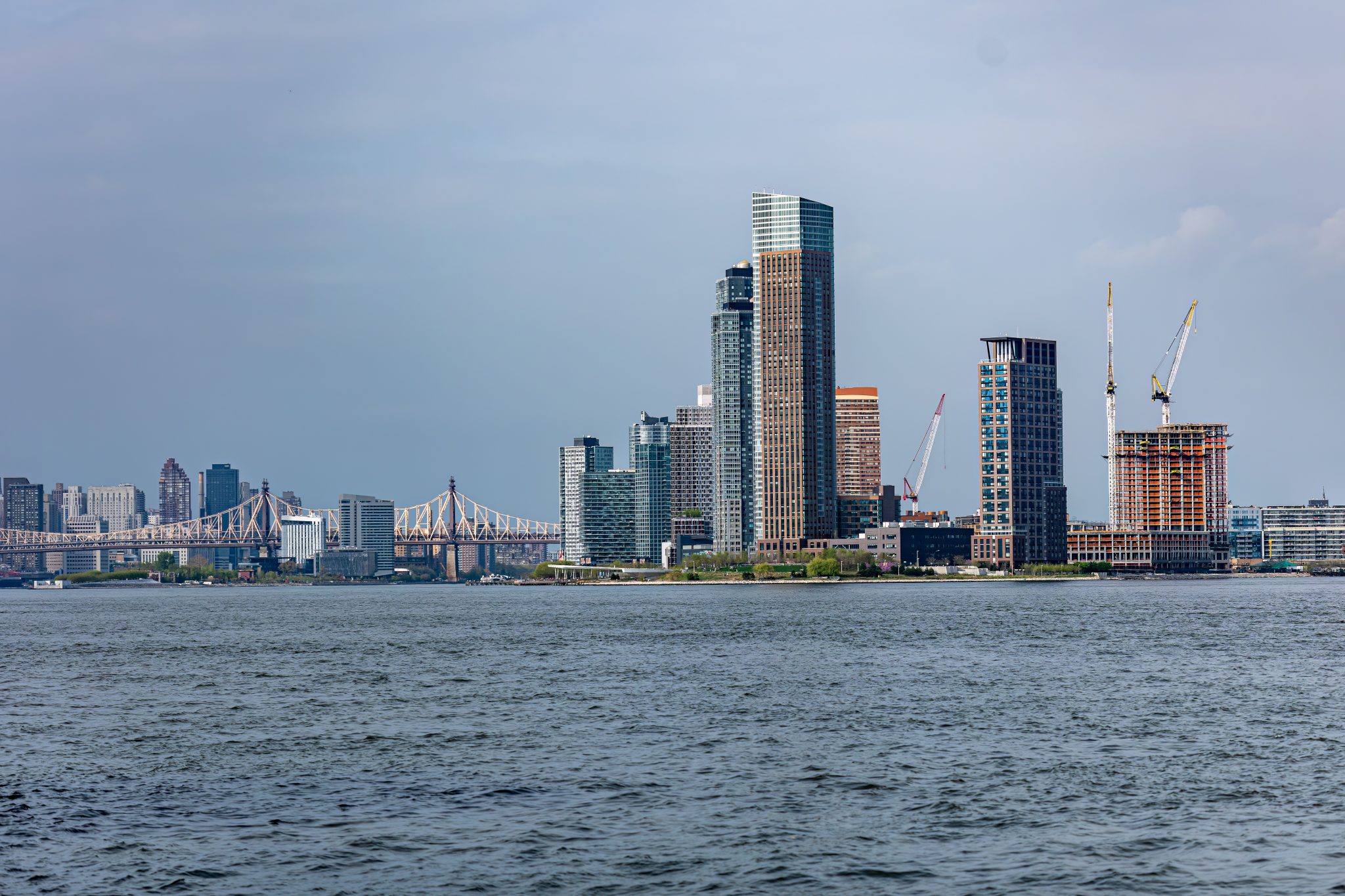 Long Island City skyline and the Queensboro bridge with the east river in the foreground