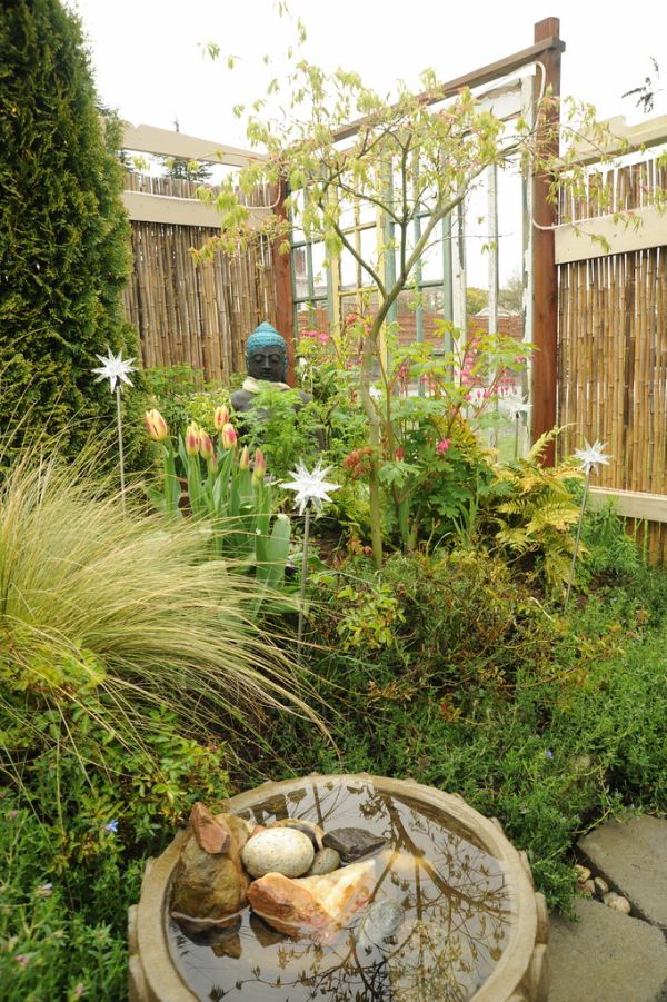Tulips among the stars, fountain with stones and pool water for the birds, Buddha meditating statue, plants, glass windows, spring, Japanese maple, Mexican grass, ferns, A Garden for the Buddha, Seatt...